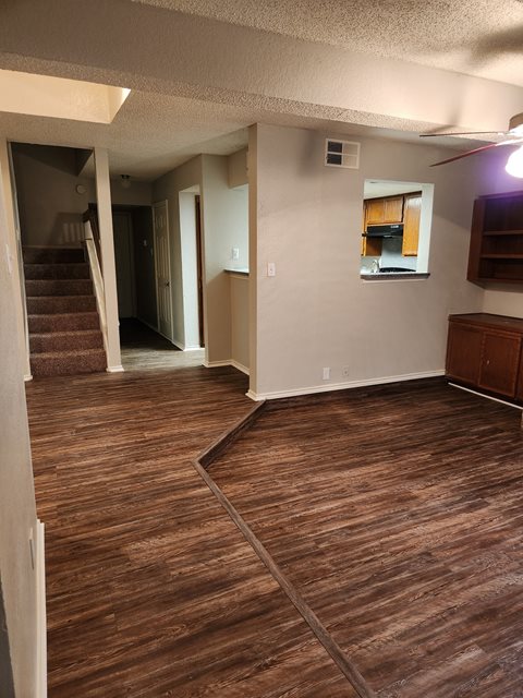 an empty living room with a hardwood floor